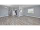 Living room and kitchen space featuring light gray walls and updated flooring at 2525 W Bay Dr # A46, Largo, FL 33770