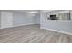 A spacious living room and kitchen with light gray walls and updated flooring at 2525 W Bay Dr # A46, Largo, FL 33770