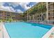 Outdoor community pool surrounded by lounge chairs and a white fence at 2525 W Bay Dr # A46, Largo, FL 33770