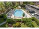An outdoor community pool with lounge chairs and nearby parking at 2525 W Bay Dr # A46, Largo, FL 33770