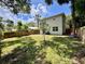 This backyard features a privacy fence and ample green space, ideal for entertaining or enjoying nature at 2612 E 26Th Ave, Tampa, FL 33605