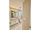 Bathroom includes tiled floors, granite counters, modern vanity and a window with blinds at 2612 E 26Th Ave, Tampa, FL 33605