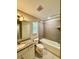 Bathroom includes a bathtub with tiled surround, vanity with mirror and granite top at 2612 E 26Th Ave, Tampa, FL 33605