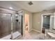 Bathroom features modern gray tiled shower, granite countertops, and tile flooring at 2612 E 26Th Ave, Tampa, FL 33605