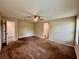 Large, carpeted bedroom featuring a ceiling fan, with doorway view into closet space at 2612 E 26Th Ave, Tampa, FL 33605