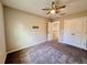 Bedroom with neutral walls, carpet, ceiling fan, and a closet with double doors at 2612 E 26Th Ave, Tampa, FL 33605
