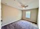 Bedroom with neutral walls, carpet, ceiling fan, and a window with horizontal blinds at 2612 E 26Th Ave, Tampa, FL 33605