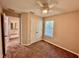 Bedroom features neutral walls, carpet, ceiling fan, window and a bathroom in view at 2612 E 26Th Ave, Tampa, FL 33605