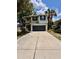 Two-story home featuring a gray garage door, neat landscaping, and light gray trim at 2612 E 26Th Ave, Tampa, FL 33605