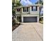 Two-story home featuring a gray garage door, neat landscaping, and light gray trim at 2612 E 26Th Ave, Tampa, FL 33605