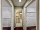 Hallway featuring doors to walk-in closets and a bathroom with vanity and sink at 2612 E 26Th Ave, Tampa, FL 33605