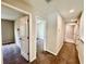 Second floor hallway with neutral walls, carpet, and doors leading to bedrooms and bathrooms at 2612 E 26Th Ave, Tampa, FL 33605