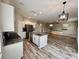 Kitchen featuring white cabinets, granite countertops, an island, and stainless steel appliances at 2612 E 26Th Ave, Tampa, FL 33605