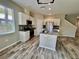 Kitchen featuring white cabinets, granite countertops, an island, and stainless steel appliances at 2612 E 26Th Ave, Tampa, FL 33605