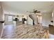 Open concept living area featuring wood-look tile floors, an open staircase, and a kitchen at 2612 E 26Th Ave, Tampa, FL 33605