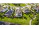 A stunning aerial view of the property showcases a screened pool, lush green lawn, and neighborhood at 2812 Long Bow Way, Odessa, FL 33556