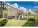 Lush backyard with a play set and screened-in patio. Perfect for enjoying outdoor activities at 2812 Long Bow Way, Odessa, FL 33556