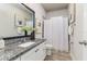 Bathroom showcases a vanity with granite counters, a framed mirror, a shower and tub, and tile floors at 2812 Long Bow Way, Odessa, FL 33556