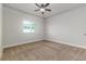 Bedroom with a ceiling fan, carpet, neutral walls, and a window providing natural light at 2812 Long Bow Way, Odessa, FL 33556