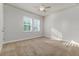 Bedroom featuring a ceiling fan, carpeted floors, white walls, and plantation shutters on the windows at 2812 Long Bow Way, Odessa, FL 33556