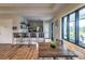 A bright clubhouse kitchen area features a bar with seating and a view to a patio area at 2812 Long Bow Way, Odessa, FL 33556