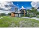 Modern clubhouse exterior shows well maintained lawn, modern architecture, and community logo at 2812 Long Bow Way, Odessa, FL 33556