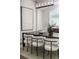 Modern dining room featuring a dark wood table, stylish chairs, and contemporary light fixture at 2812 Long Bow Way, Odessa, FL 33556