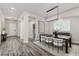 Bright dining room with wood-look floors, modern chandelier, and stylish decor at 2812 Long Bow Way, Odessa, FL 33556