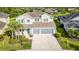 Stunning aerial view of a well-manicured two-story home with a three-car garage and lush landscaping at 2812 Long Bow Way, Odessa, FL 33556