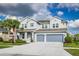 Traditional two-story home featuring a neutral color palette and a two-car garage at 2812 Long Bow Way, Odessa, FL 33556