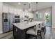 Modern kitchen with a spacious island, stainless steel appliances, and white countertops at 2812 Long Bow Way, Odessa, FL 33556
