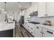 Modern kitchen features white cabinets, stainless steel appliances, and a spacious island at 2812 Long Bow Way, Odessa, FL 33556