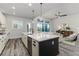Open concept kitchen with center island flows into a cozy living room with great natural light at 2812 Long Bow Way, Odessa, FL 33556