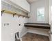 Functional laundry room features granite countertop, tiled floors, overhead cabinets, and utility connections at 2812 Long Bow Way, Odessa, FL 33556