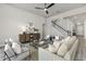 Bright living room with a ceiling fan, comfortable seating, staircase and stylish decor at 2812 Long Bow Way, Odessa, FL 33556