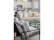 Comfortable living room with modern decor, a plush sofa, a stylish accent chair, and kitchen views at 2812 Long Bow Way, Odessa, FL 33556