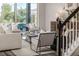 Cozy living room with comfortable seating, large windows, and an attractive staircase with decor at 2812 Long Bow Way, Odessa, FL 33556