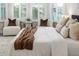 Close up of bright main bedroom with comfortable seating by window at 2812 Long Bow Way, Odessa, FL 33556