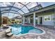 Beautiful backyard with a screened-in pool, spa, and lounge area, perfect for relaxation at 2812 Long Bow Way, Odessa, FL 33556