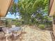 A lovely outdoor patio with a table and chairs surrounded by lush greenery and a variety of plants and trees at 3354 52Nd N St, St Petersburg, FL 33703