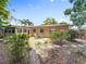 Serene backyard featuring a stone patio with outdoor seating, surrounded by lush greenery at 3354 52Nd N St, St Petersburg, FL 33703