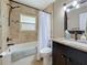 Bathroom features a tub and shower combo with granite countertops and a large framed mirror at 3354 52Nd N St, St Petersburg, FL 33703