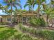 Inviting home exterior featuring tropical landscaping, a front door, and a manicured lawn at 3354 52Nd N St, St Petersburg, FL 33703