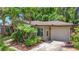 A charming home with a well-maintained exterior, showcasing its garage and manicured landscaping at 3354 52Nd N St, St Petersburg, FL 33703