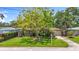Home's exterior features a lush front yard, mature trees, and well-maintained landscaping at 3354 52Nd N St, St Petersburg, FL 33703