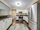 Kitchen with white cabinetry, stainless steel appliances, granite countertops, and hardwood floors at 3354 52Nd N St, St Petersburg, FL 33703