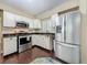 Kitchen featuring stainless steel appliances, granite countertops, and white cabinetry at 3354 52Nd N St, St Petersburg, FL 33703
