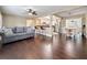 Open-concept living area with hardwood floors, a gray sofa, and bar seating near the kitchen at 3354 52Nd N St, St Petersburg, FL 33703