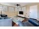 Bright living room with a ceiling fan, hardwood floors, and plantation shutters allowing lots of natural light at 3354 52Nd N St, St Petersburg, FL 33703