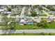 Well-situated neighborhood with lush landscaping, showcasing a home with solar panels and a refreshing backyard pool at 3519 Richboro Dr, Holiday, FL 34691